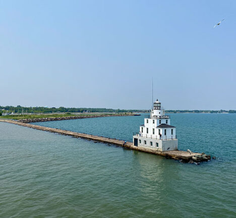 View of the Manitowoc Breakwater Lighthouse with the shore in the distance.