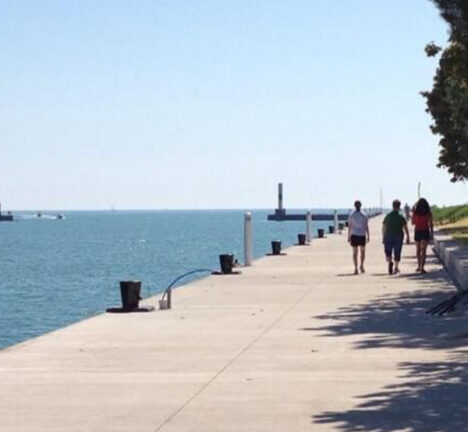 People walking along the waterfront on a sunny day.
