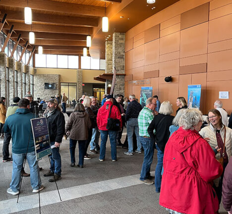 Groups of people talking outside of an event.