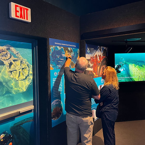 Two people examining a museum exhibit.