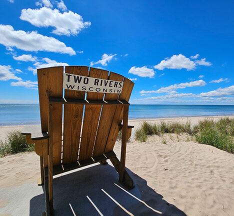 Beach chair set on a beach under a blue sky.