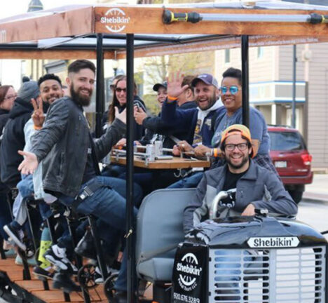Group of people riding on a pedal bus.