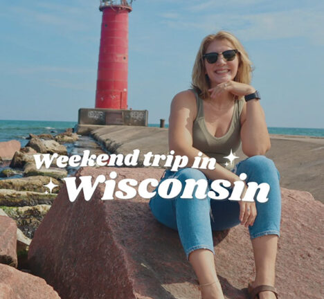Cover of the Sheboygan Visitor guide featuring a woman seated in front of a lighthouse.