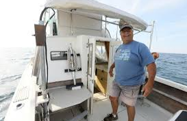 Stee Radovan standing on a boat.